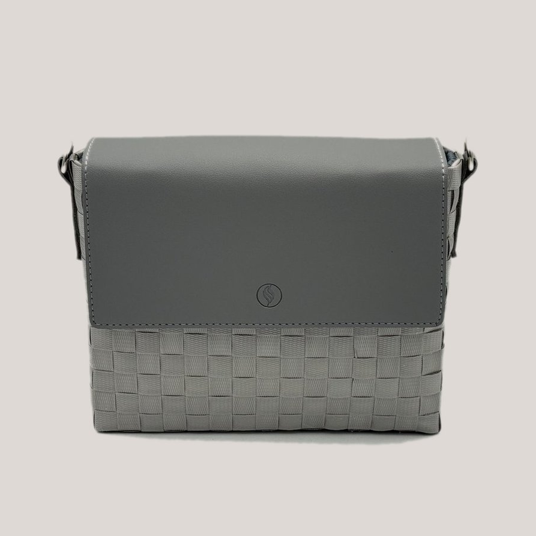 Gray handbag with woven pattern on a light gray background